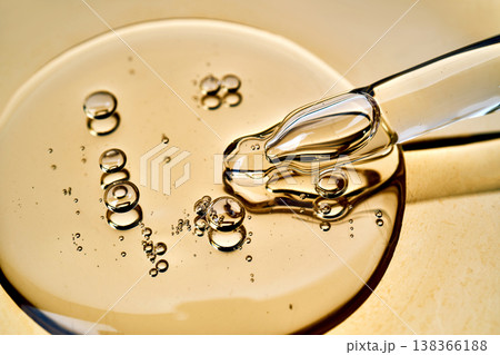 Golden cosmetic oil dropper with liquid bubbles 138366188
