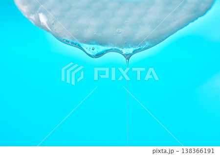 Viscous gel dripping from cotton pad beauty treatment 138366191