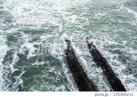 Ocean Waves Hitting Cliff with Sandy Beach Foreground Ocean Waves Hitting Cliff with Sandy Beach Foreground 138366212