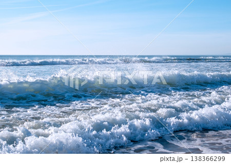 Powerful Sea Waves Rolling onto Sandy Beach Below Cliff 138366299