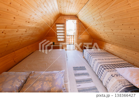 Homestay bedroom with wooden walls, two beds, soft light, and warm interior Homestay bedroom with wooden walls, two beds, soft light, and warm interior 138366427