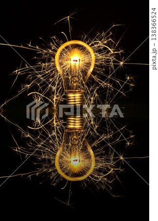 Light bulb sparkling in the dark and glowing glass 138366524