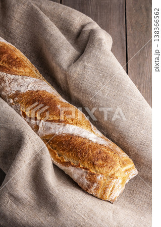 Freshly baked french baguette in on wooden background. High quality photo 138366562