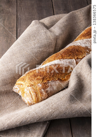 Freshly baked french baguette in on wooden background. High quality photo 138366575