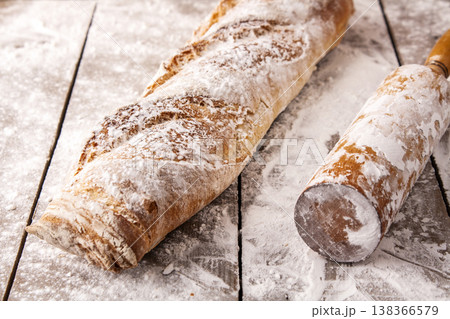 Freshly baked french baguette in on wooden background. High quality photo 138366579