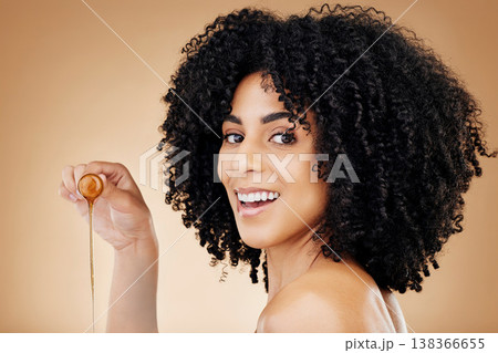 Hair, honey or oil with woman and beauty, natural cosmetics for growth and skin isolated on studio background. Health, haircare with texture and serum product, salon treatment and smile in portrait 138366655
