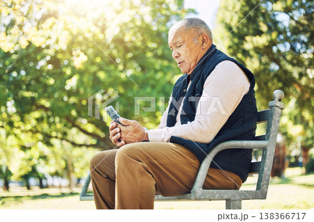 Senior man, garden and browsing on phone for social media, learning and network with internet or technology on park bench, nature and outdoors. Elderly person, email and chat on smartphone or mobile Senior man, garden and browsing on phone for social media, learning and network with internet or technology on park bench, nature and outdoors. Elderly person, email and chat on smartphone or mobile 138366717