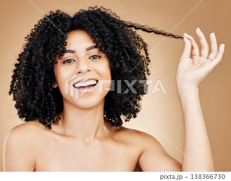 Curly, hair strand and portrait of woman in studio for natural beauty, healthy growth and coil textures on brown background. Happy model pull afro hairstyle for salon aesthetic, keratin and treatment Curly, hair strand and portrait of woman in studio for natural beauty, healthy growth and coil textures on brown background. Happy model pull afro hairstyle for salon aesthetic, keratin and treatment 138366730
