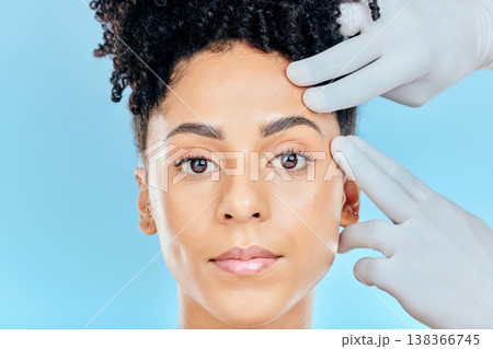 Change, plastic surgery and portrait of woman with hands on face in studio for cosmetic facial consultation. Skincare, dermatology and professional collagen therapy, beauty model on blue background. 138366745