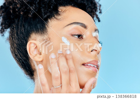 Beauty, face and relax woman with cream dermatology of ointment, lotion and feel skin texture, hydration results or cosmetics. Skincare makeup, anti aging or studio model profile on blue background 138366818