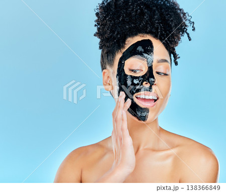 Skincare, face mask and woman in studio for charcoal facial treatment, anti aging and wellness. Beauty salon, dermatology and face of person for health, cosmetics or grooming on blue background 138366849