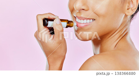 Closeup, woman and beauty with lip balm in studio with mockup for treatment on pink background to hydrate. Female model, smile and cosmetic for dermatology with omega 3, vitamin c and hyaluronic acid Closeup, woman and beauty with lip balm in studio with mockup for treatment on pink background to hydrate. Female model, smile and cosmetic for dermatology with omega 3, vitamin c and hyaluronic acid 138366880