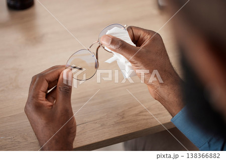 Hands, glasses and fabric for cleaning, closeup and maintenance for dust, frame and eye health in home. Person, cloth and spectacles for optometry, vision and wellness for eyesight at table in house Hands, glasses and fabric for cleaning, closeup and maintenance for dust, frame and eye health in home. Person, cloth and spectacles for optometry, vision and wellness for eyesight at table in house 138366882