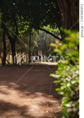 In a green city park, people running along the path In a green city park, people running along the path 138366953