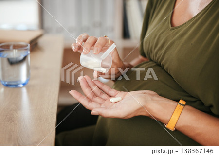 Drugs in hand, pregnant woman with health and supplement for baby, prescription and prenatal vitamins at desk. Medicine at work, healthcare and pharmaceutical pills for healthy pregnancy and iron 138367146