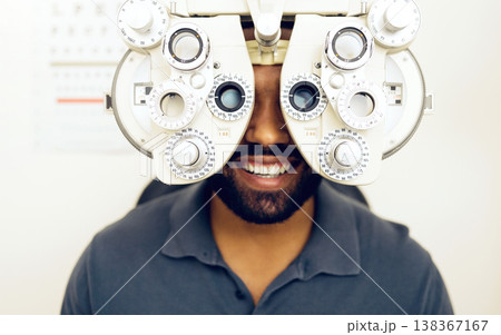 Eye test, face or happy man consulting to help eyesight at optometrist for a optical assessment. Optometry, wellness or customer in clinic for vision, iris or retina health with machine or phoropter Eye test, face or happy man consulting to help eyesight at optometrist for a optical assessment. Optometry, wellness or customer in clinic for vision, iris or retina health with machine or phoropter 138367167
