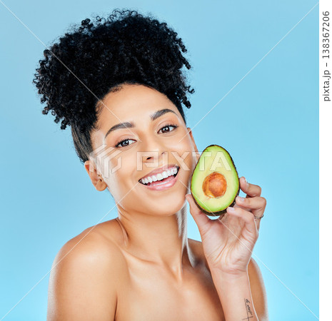 Happy woman, portrait and avocado for natural skincare, beauty or diet against a blue studio background. Face of female person smile with organic vegetable for nutrition, vitamin C or skin wellness 138367206