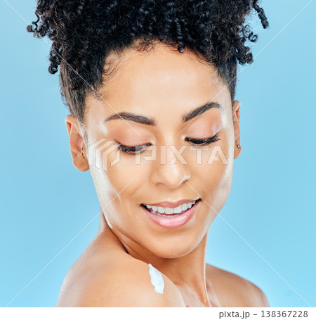Skincare, face and happy woman with body cream, lotion or moisturizer for self care, collagen treatment or skin hydration. Sunscreen protection, shoulder and studio model smile on blue background Skincare, face and happy woman with body cream, lotion or moisturizer for self care, collagen treatment or skin hydration. Sunscreen protection, shoulder and studio model smile on blue background 138367228