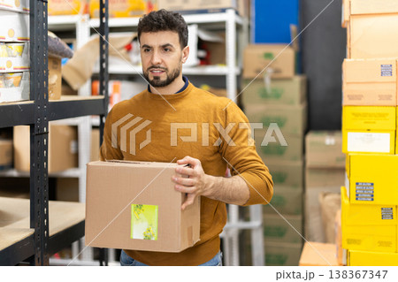 Worker loading box at warehouse store 138367347