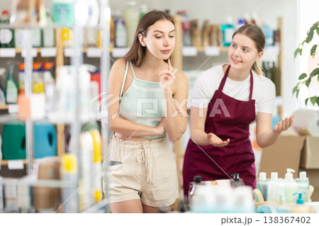 saleswoman shows a woman the range of products in a household store 138367402
