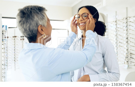 Optometry, glasses and women consulting for decision, choice and eye care option in optician store. Healthcare, ophthalmology and people in clinic for prescription lens, spectacles and vision frames Optometry, glasses and women consulting for decision, choice and eye care option in optician store. Healthcare, ophthalmology and people in clinic for prescription lens, spectacles and vision frames 138367454