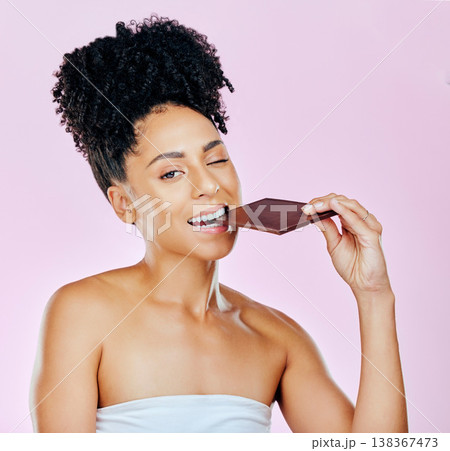 Portrait, sweet diet and woman with chocolate, eating and diabetes on a pink studio background. Face, person and model with unhealthy food, cacao treat and calories with sugar, nutrition and snack Portrait, sweet diet and woman with chocolate, eating and diabetes on a pink studio background. Face, person and model with unhealthy food, cacao treat and calories with sugar, nutrition and snack 138367473