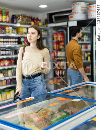 Female shopper are choosing something in food store 138367487