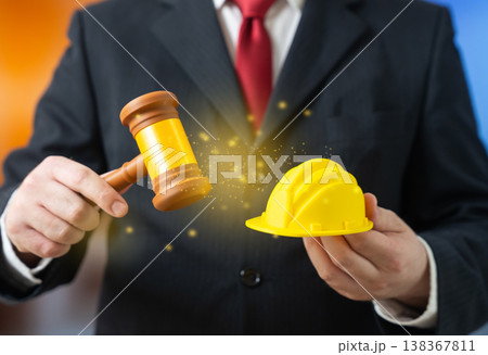 A judge with a gavel and a yellow hard hat represents construction law. Permits and worker rights. Safety rules, compensation, and legal regulation ensure compliance and workplace protection 138367811