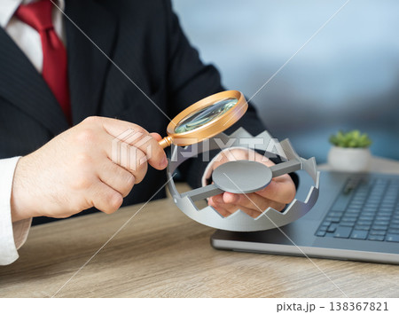 A businessman studies a trap revealing fraud risks in business. Illegal schemes and deception. Risk awareness, investigation, and compliance help prevent financial loss and protect operations A businessman studies a trap revealing fraud risks in business. Illegal schemes and deception. Risk awareness, investigation, and compliance help prevent financial loss and protect operations 138367821