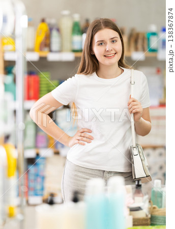 Young woman chooses household chemicals in store 138367874