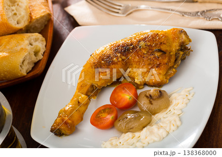 Roasted chicken leg quarter with baked onions and sauce Roasted chicken leg quarter with baked onions and sauce 138368000
