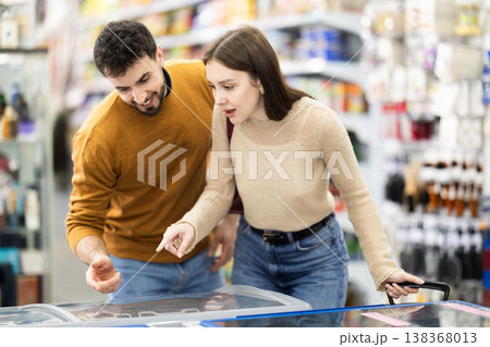 Young couple choosing frozen food in grocery store 138368013