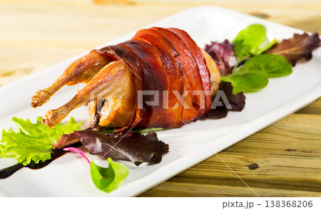 Image of baked in bacon quail with balsamic sauce on the plate 138368206