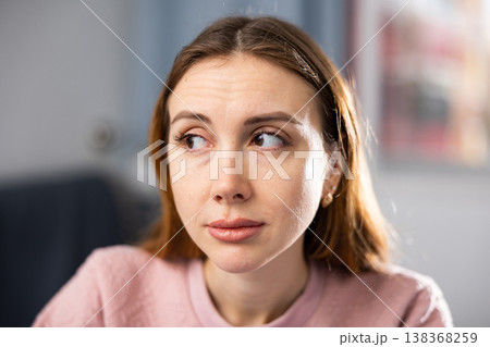 Portrait of a young woman performing a gymnastic exercise for the eyes 138368259