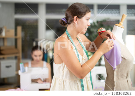 Atelier Worker Sewing Clothes Next to Dressmaker 138368262