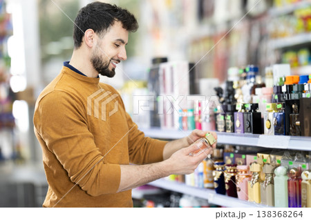 Young man chooses perfume in store 138368264