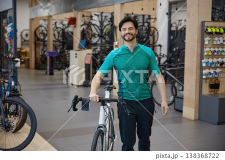 Enthusiastic bicycle expert guides amidst shop displays and gear Enthusiastic bicycle expert guides amidst shop displays and gear 138368722