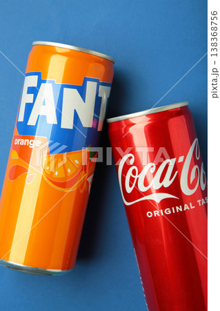 Mykolaiv, Ukraine - March 25, 2026: Can of Coca Cola Coke original taste with can of Fanta Original soft drink with orange juice on blue background. Mykolaiv, Ukraine - March 25, 2026: Can of Coca Cola Coke original taste with can of Fanta Original soft drink with orange juice on blue background. 138368756