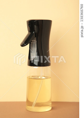 Cooking oil glass sprayer on beige background. Space for text Cooking oil glass sprayer on beige background. Space for text 138368760