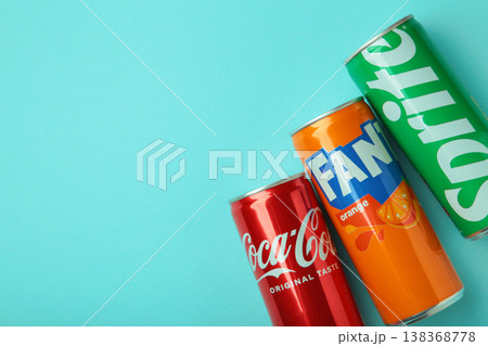 Mykolaiv, Ukraine - March 25, 2026: Iron cans of Coca Cola, Fanta and Sprite drink on blue background. Mykolaiv, Ukraine - March 25, 2026: Iron cans of Coca Cola, Fanta and Sprite drink on blue background. 138368778