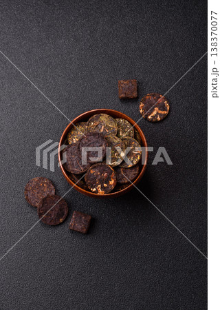 Organic Chinese green pu-erh tea with various herbs in round bricks. Chinese pu-erh tea 138370077
