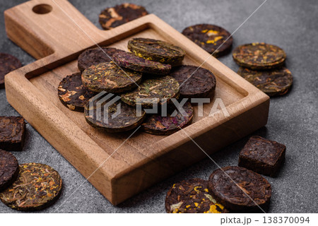 Organic Chinese green pu-erh tea with various herbs in round bricks. Chinese pu-erh tea 138370094
