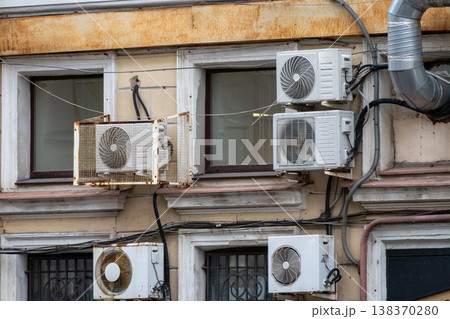 air conditioning on facade of building, air cooling in hot weather. air conditioning on facade of building, air cooling in hot weather. 138370280