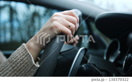 Female Hands On A Steering Wheel, Girl Driver In Family Car Female Hands On A Steering Wheel, Girl Driver In Family Car 138370322