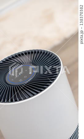 Modern air purifier with sleek design and intuitive controls, enhancing indoor air quality and promoting a healthier living environment Modern air purifier with sleek design and intuitive controls, enhancing indoor air quality and promoting a healthier living environment 138370382