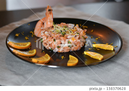 Fresh salmon tartare with shrimp citrus garnish gourmet seafood plate Fresh salmon tartare with shrimp citrus garnish gourmet seafood plate 138370628