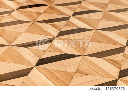 Geometric wooden parquet floor featuring inlaid triangle panels Geometric wooden parquet floor featuring inlaid triangle panels 138370776