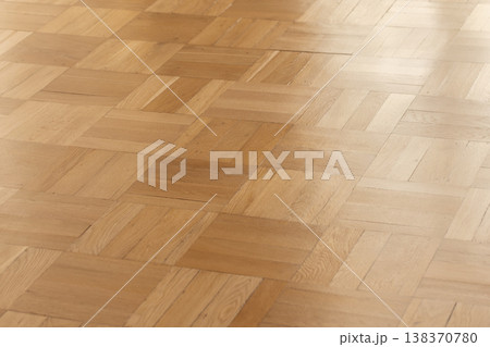 Smooth oak parquet hardwood floor with a warm natural finish and subtle sheen Smooth oak parquet hardwood floor with a warm natural finish and subtle sheen 138370780