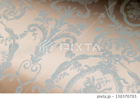 Soft beige fabric with an ornate blue damask pattern, close up photo 138370783
