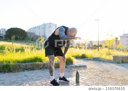 Tired man resting after intense outdoor workout Tired man resting after intense outdoor workout 138370810